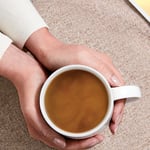 moccona hands holding cup of coffee